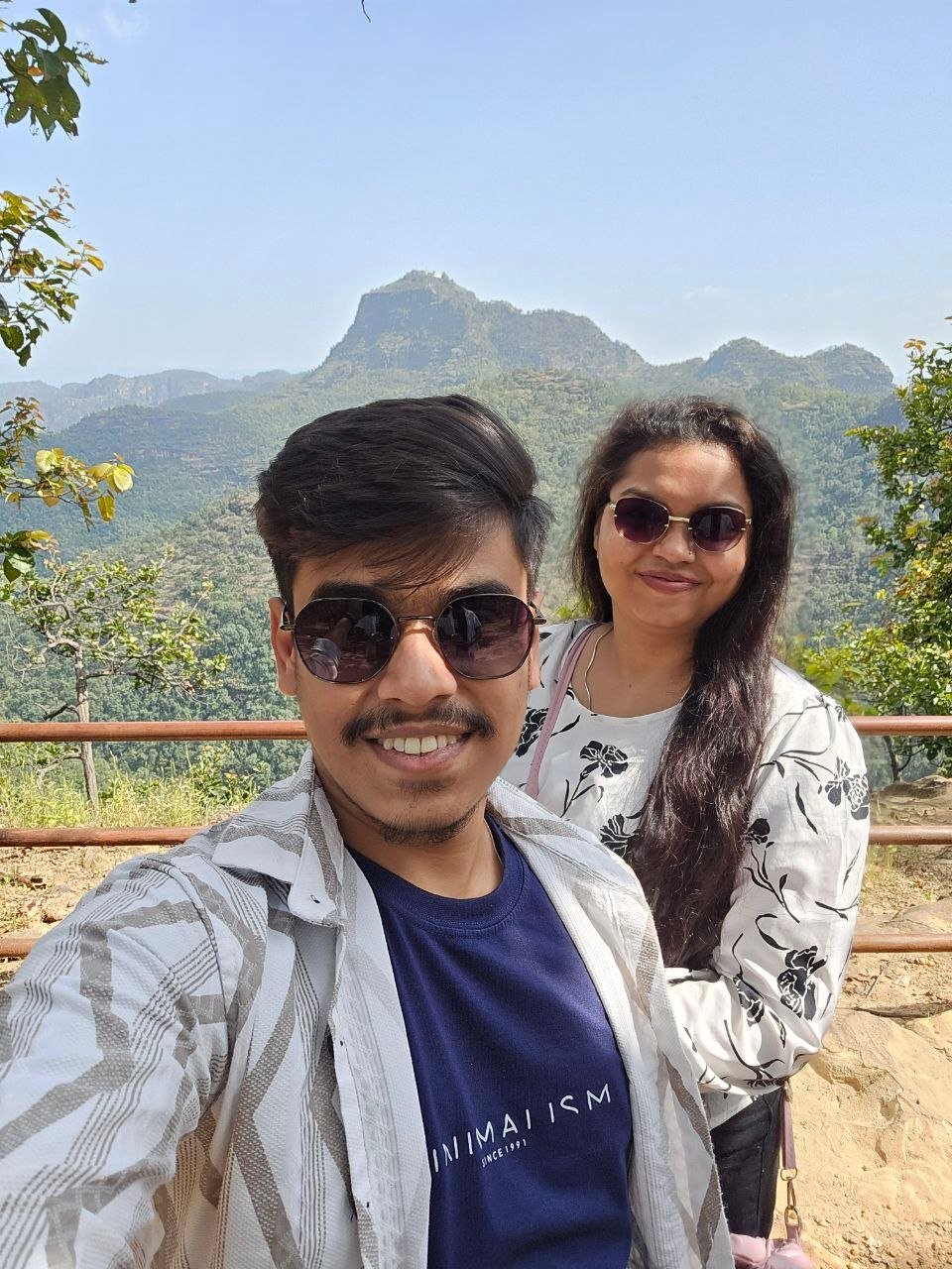 Selfie on a hilltop with mountains behind
